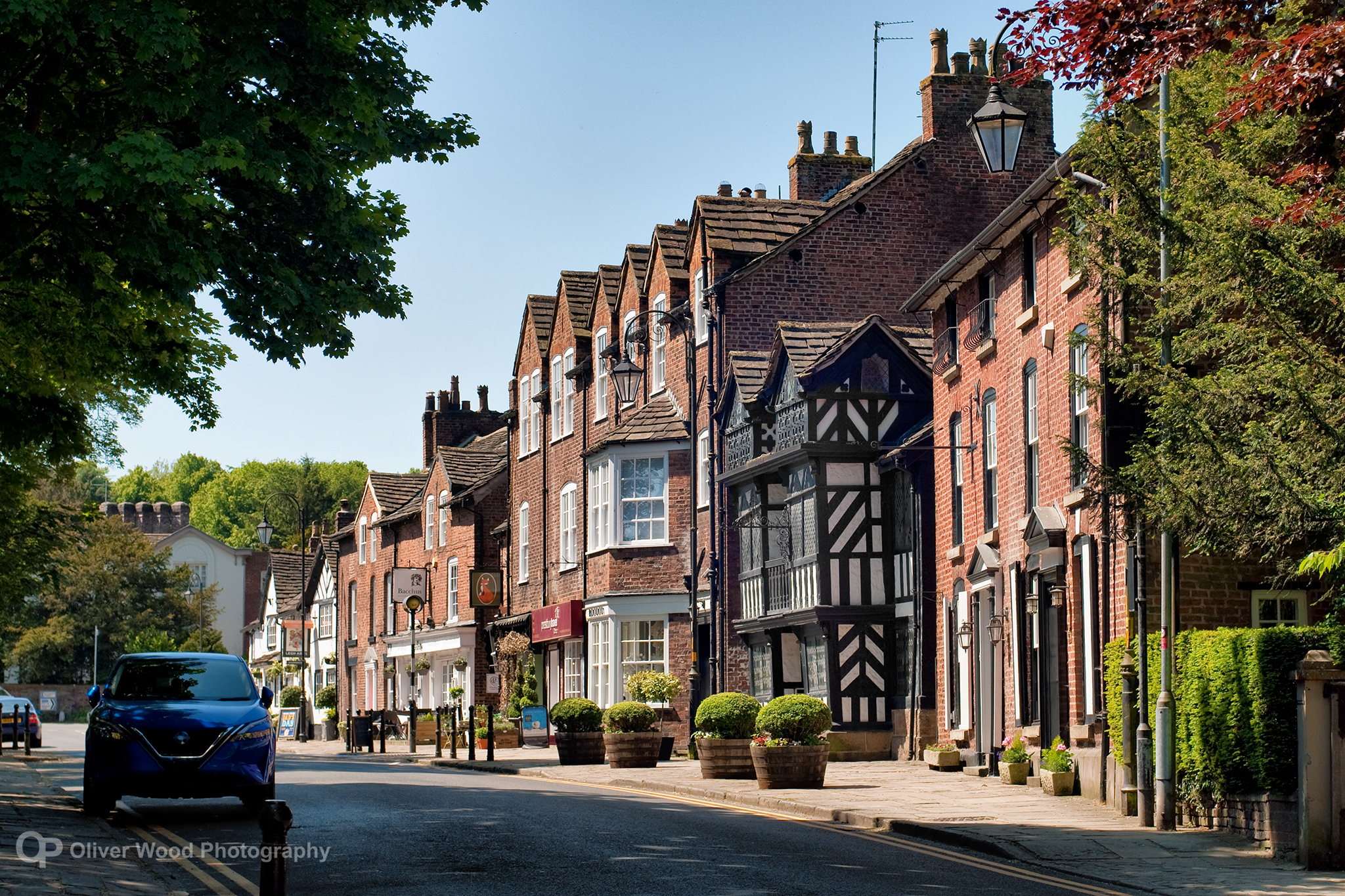 Historic street in Prestbury, Cheltenham with traditional buildings and village charm.
