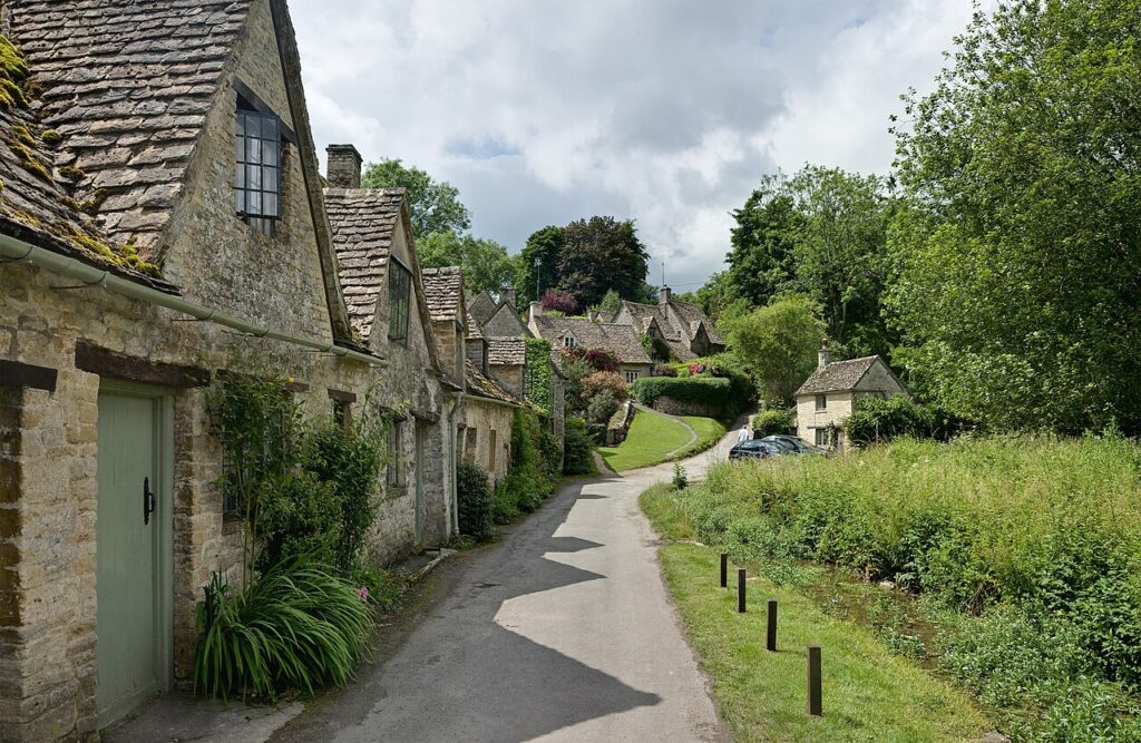 Traditional stone cottages along a quiet lane in Bibury, Cotswolds
