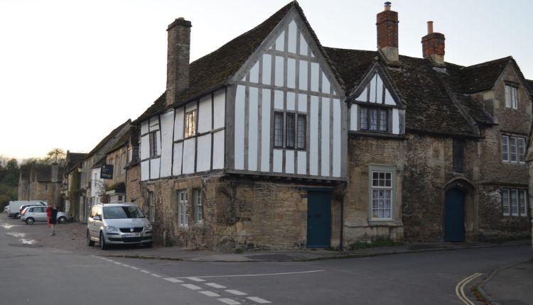 Traditional half-timbered and stone cottages on a quiet street in Lacock village, Wiltshire