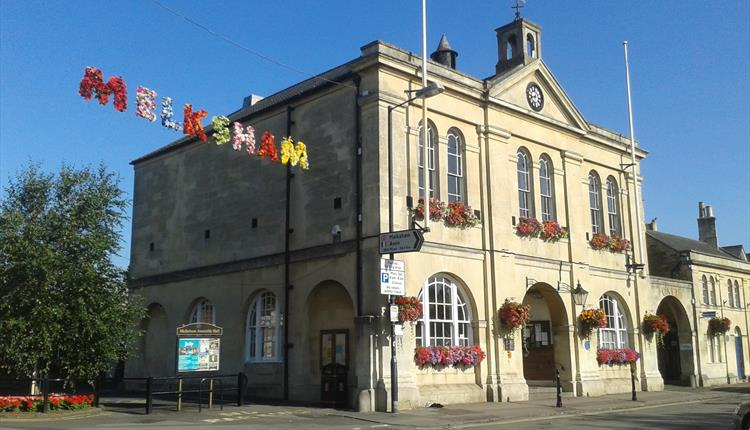 Melksham Town Hall decorated with flowers on a sunny day in Melksham, Wiltshire