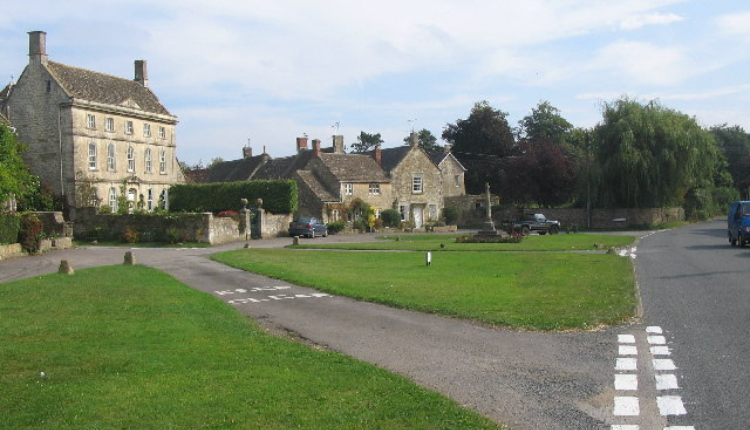 Stone cottages and village green in Biddestone, a traditional Cotswold village in Wiltshire