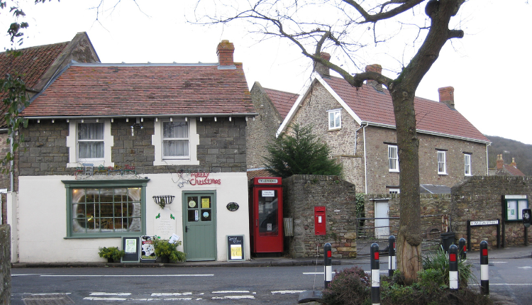 Village street scene in Walton-in-Gordano with stone cottages, a traditional pub, and road junction