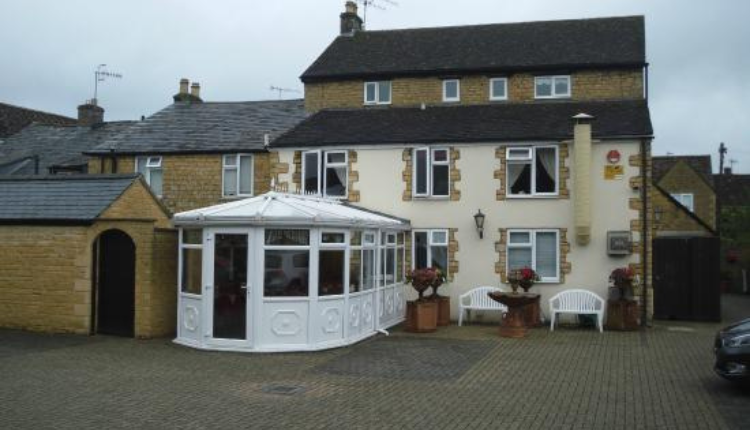 Broadlands Hotel in Bourton-on-the-Water with traditional Cotswold stone exterior and courtyard entrance