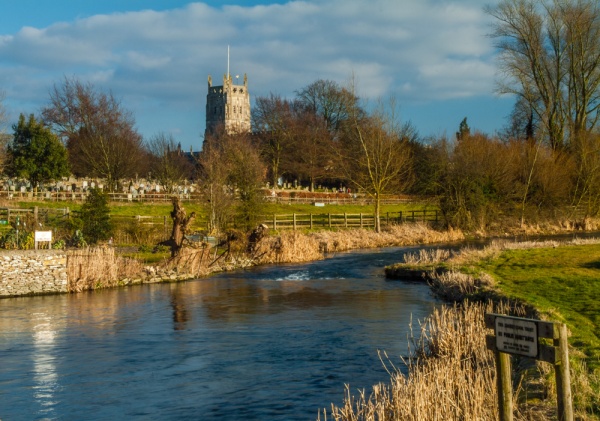 River scene in Fairford with St Mary’s Church in the background.