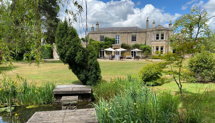 Guyers House Hotel in Corsham with landscaped gardens, pond, and historic country house building