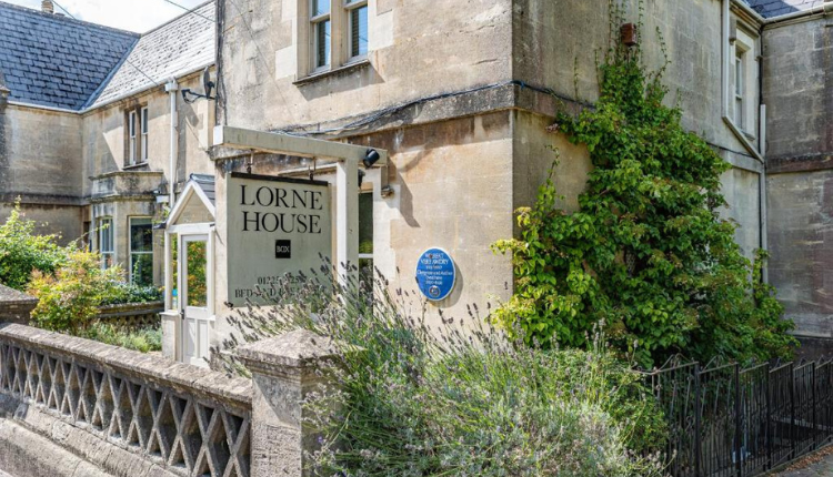 Lorne House Hotel in Box featuring a historic stone exterior and entrance sign