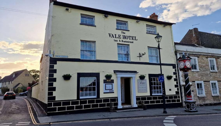 The Vale Hotel in Cricklade, a traditional cream-painted inn and restaurant on a historic Wiltshire street.
