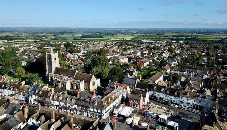 Aerial view of Highworth town showing the historic church, market square, and surrounding countryside.