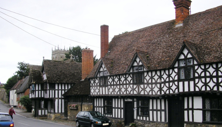 Traditional black-and-white timber-framed cottages lining a village street in Potterne, Wiltshire