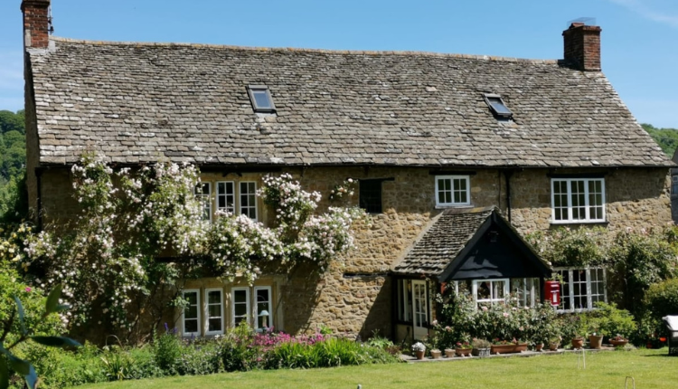 Stone-built exterior of Forthay Bed & Breakfast with a pitched roof, cottage garden, and traditional English countryside setting.