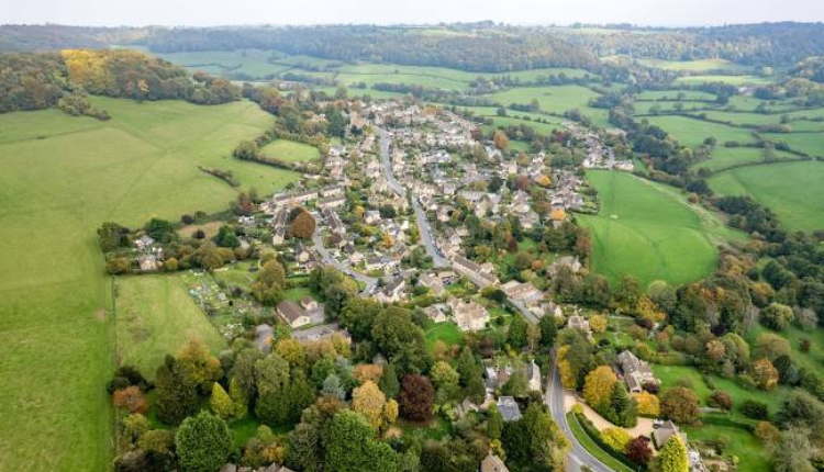Aerial view of Uley village surrounded by rolling green countryside in Gloucestershire.