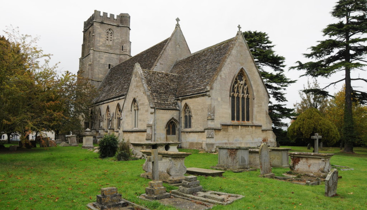 St Bartholomew’s Church surrounded by gravestones in the village of Coaley, Gloucestershire.