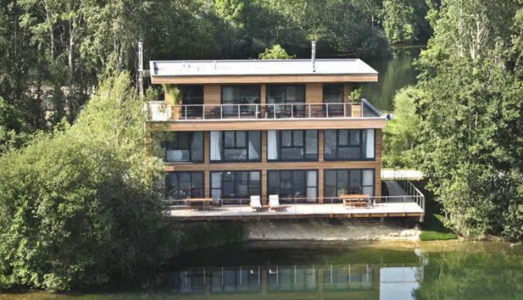 Luxury lakeside homes at The Lakes by Yoo surrounded by water and countryside.