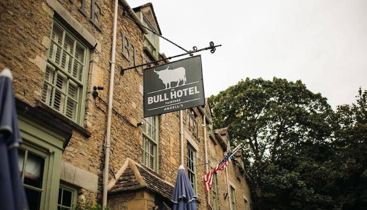 Exterior of The Bull Hotel in Fairford with traditional stone façade.